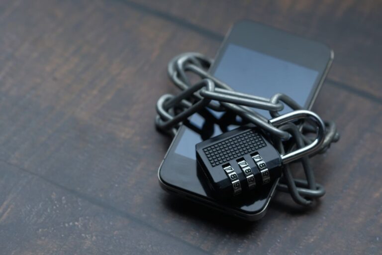 Smartphone secured with a padlock and chain, representing the September 2026 Apple security update
