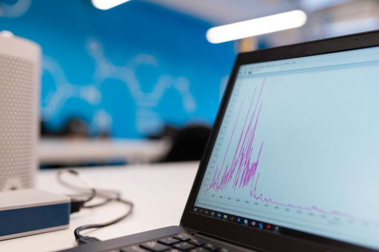Laptop screen displaying an analytics graph, representing Google Ads AI Max campaign performance reporting