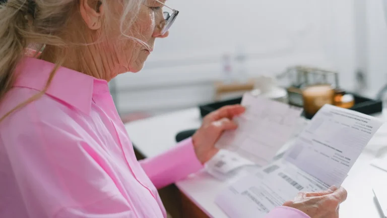 Older couple reviewing Medicare prescription drug plan paperwork at home