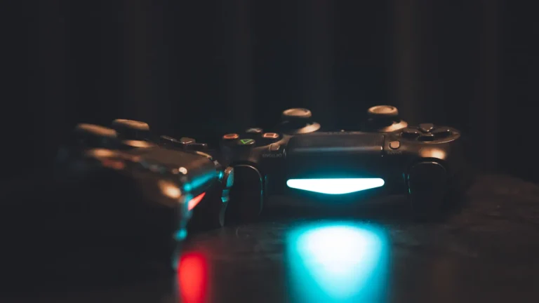 Two video game controllers glowing under moody ambient lighting, representing October 2026's major game releases