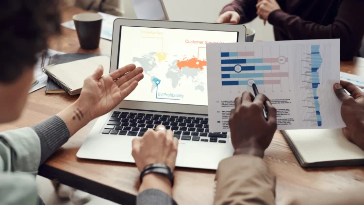Business team reviewing financial charts and restructuring documents in a meeting room