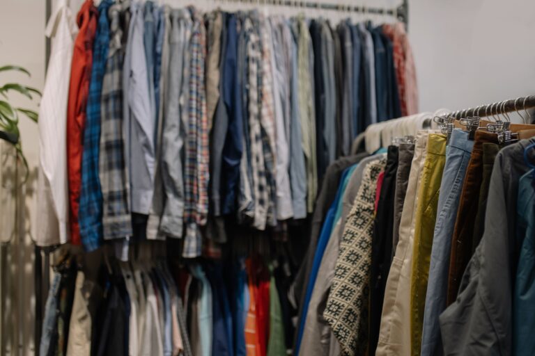 Racks of assorted secondhand clothing in a thrift and resale shop