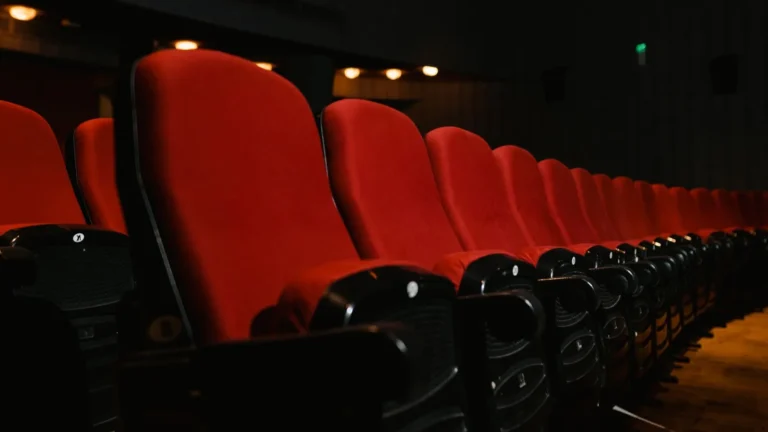 Rows of empty red seats in a movie theater before a screening