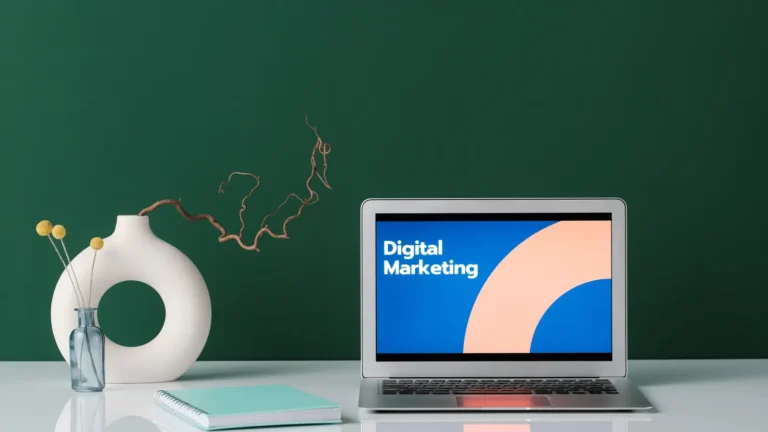 Laptop on a white desk showing a digital marketing screen