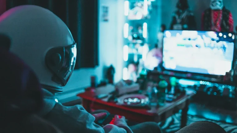 Gamer playing a video game on a TV in a dark room