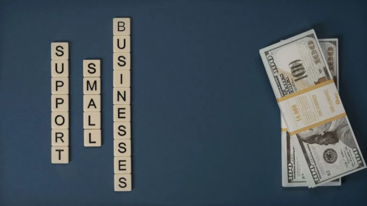 Letter tiles and cash representing financing for small businesses